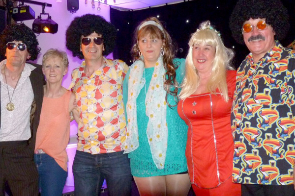 Members dressed for ABBA Tribute Night